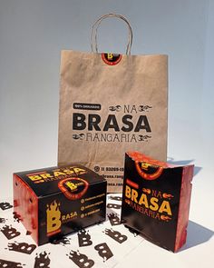 two brown bags sitting next to each other on top of a white table with black letters