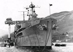 an old photo of a large ship in the water with mountains in the background and snow on the ground