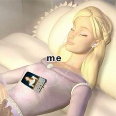 a woman laying on top of a white couch next to an mp3 player