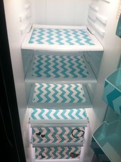 an open refrigerator with blue and white chevrons