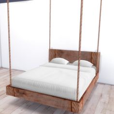 a bed that is made out of wood and has white sheets on top of it