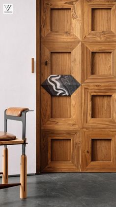 a wooden door with two chairs next to it