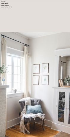 a living room with white walls and wood floors