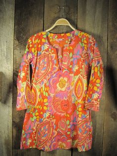 Cotton tunic in bright, colorful floral print. 100% cotton v-neck, side slits, quarter sleeves, mid-thigh length light sheer hand wash, hang dry due to the craf Summer V-neck Tunic With Vibrant Print, Vibrant Print V-neck Tunic, Spring Multicolor V-neck Tunic, Spring Tunic With Vibrant Print, Patterned Long Sleeve Floral Tunic, Spring Vibrant Print Tunic, Long Sleeve Floral Print Patterned Tunic, Multicolor Floral Print Spring Tunic, Patterned V-neck Tunic For Summer