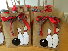 three brown paper bags with bowling pins on them