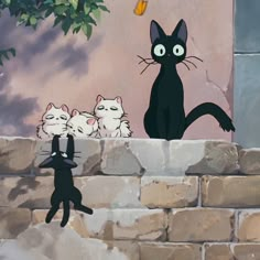 three black cats sitting on top of a brick wall next to a cat and two kittens