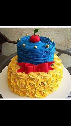 the cake is decorated with yellow and blue icing