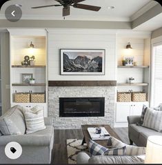 a living room filled with furniture and a fire place under a ceiling mounted flat screen tv