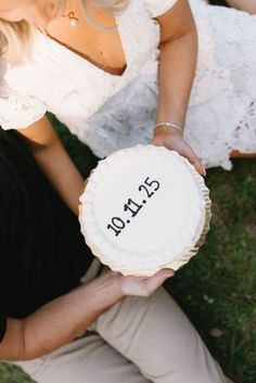 a man and woman holding a cake with the number 21 on it