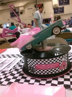 a record player sitting on top of a black and white checkered table