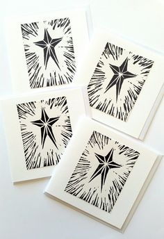 four black and white cards with star designs on them