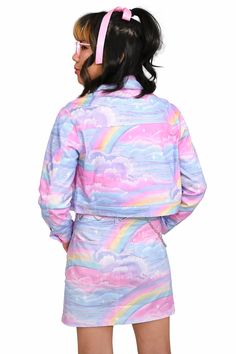 Sky Dancer Cropped Jacket features a dazzling pastel rainbow cloud print on lightweight twill fabric, crowned with pretty pink metal buttons. Two functional pockets. Wash separately, dry clean recommended. Do not tumble dry. Warm iron. Part of our My Violet Originals. Designed by us and made by our reputable production partner in China. Our dark haired model with pink ribbon is 5'0 wearing XSRainbow haired model is 5'7" wearing size LargeDark hair model with space buns is 5'2 wearing a 2X Trendy Rainbow Long Sleeve Outerwear, Trendy Rainbow Outerwear For Spring, Space Buns, Cloud Print, Hair Model, Rainbow Cloud, Collar Jewelry, Cropped Jacket, Twill Fabric