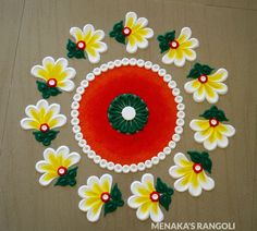 a decorated table top with flowers and green leaves on the edge, surrounded by red and white circles