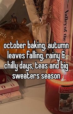 a candle and some books on a table with the words october baking, autumn leaves falling, rainy & chilly days, teas and big sweaters season