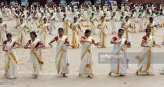 a group of women in sari dancing on the beach