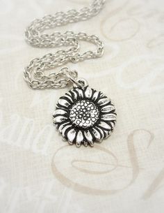 I think this is afforable! Silver Sunflower Pendant Jewelry, Silver Jewelry With Sunflower Design Flower Pendant, Silver Metal Flower Pendant Necklace, Adjustable Silver Charm Necklace With Flower Pendant, Adjustable Silver Flower Charm Necklace, Silver Charm Necklace With Flower Pendant, Silver Adjustable Flower Pendant Charm Necklace, Adjustable Silver Flower Charm Necklaces, Silver Adjustable Flower Charm Necklace