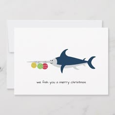 a christmas card with an image of a shark and two balls in the shape of a fish