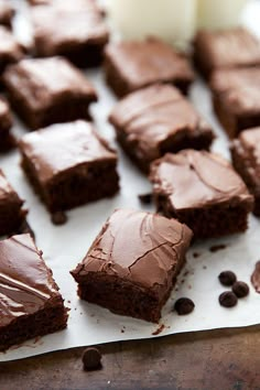 chocolate brownies with frosting on a baking sheet