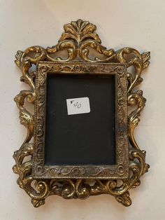 an ornate gold frame with a price tag on it