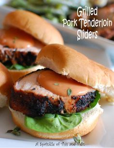 grilled pork tenderion sliders with lettuce and tomato sauce on them