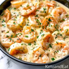 a skillet filled with shrimp and grits on top of a marble countertop