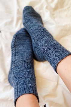 the legs of a person wearing blue jeans and socks