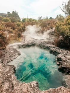 a hot spring in the middle of some rocks