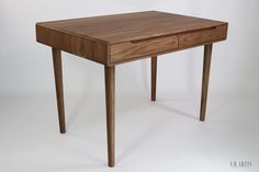 a wooden table with two drawers on one side and an open drawer on the other