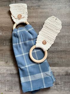 a blue and white blanket with a wooden ring on it