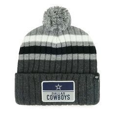 a black and white striped hat with a cowboys patch on the front, and a pom