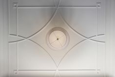 a white ceiling with a circular light on it