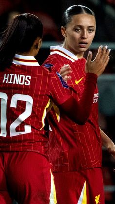 two female soccer players are congratulating each other