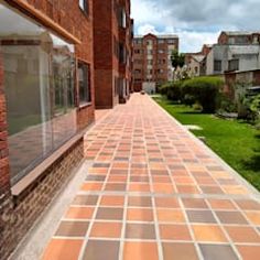 an empty brick walkway between two buildings