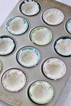 a muffin tin filled with cupcake batters sitting on top of a counter