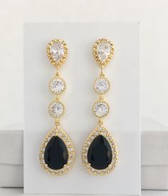 I've created these absolutely gorgeous super sparkly long black crystal earrings in gold plated brass setting. Earrings feature a large teardrop with pear cut black cubic zirconia center surrounded by tiny round zirconia crystals. Teardrop dangles from a bright cubic zirconia ear stud and two round cubic zirconia connectors. Total length of the earrings is 6 cms. For matching necklace click: https://www.etsy.com/listing/763689760/black-bridal-necklace-black-gold-crystal?ref=shop_home_active_2 Fo Glamorous Black Crystal Earrings For Wedding, Elegant Black Long Drop Chandelier Earrings, Black Dangle Chandelier Earrings For Wedding, Elegant Gold Earrings With Black Diamonds, Elegant Black Drop Bridal Earrings, Elegant Black Bridal Earrings For Formal Occasion, Wedding Gold Jewelry, Black Wedding Jewelry, Black Gold Necklace