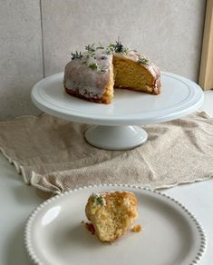 there is a piece of cake on the plate next to the other half, and one slice has been taken out of it