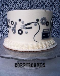 a white cake with black and silver designs on it