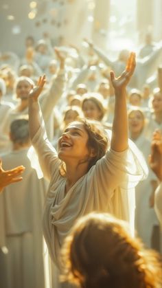 a woman with her arms in the air and hands raised above her head, surrounded by other people