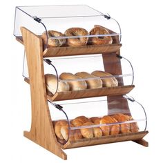 three tiered display case with bread and pastries on the bottom shelf, in front of a white background