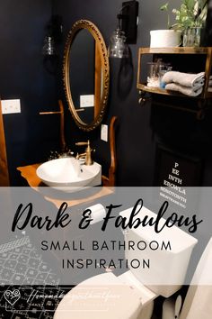 a bathroom with black walls and white fixtures, including a sink and toilet in the center