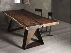 the table is made from wood and has two chairs around it, with one chair at the end