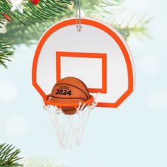 an ornament hanging from a christmas tree with a basketball in the hoop on it