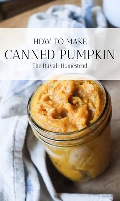 a jar filled with canned pumpkin paste on top of a table next to a towel