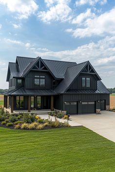 a large black house with lots of windows on the front and side of it's roof