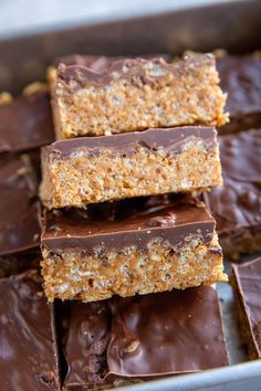 chocolate bars stacked on top of each other in a baking pan with one cut in half