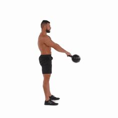 a man with no shirt is holding a medicine ball