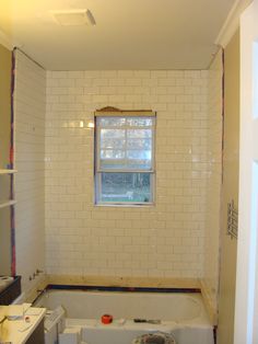 a bathroom that is being remodeled with white tile