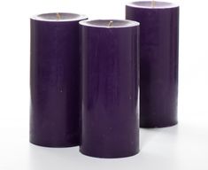 three purple candles sitting next to each other