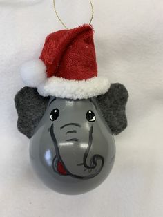 an elephant ornament with a santa hat on it