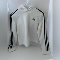 For Sale Is A White Crop Adidas Sweatshirt With A Hood. Never Worn Brand New Condition White Stretch Hooded Top, White Stretch Sweatshirt With Letter Print, White Hooded Sports Top, White Hooded Top For Sports, White Sports Hoodie, Three Stripes Long Sleeve Sportswear Top, White Stretch Sporty Sweatshirt, White Sportswear Tops For Winter, White Long Sleeve Hoodie With Three Stripes